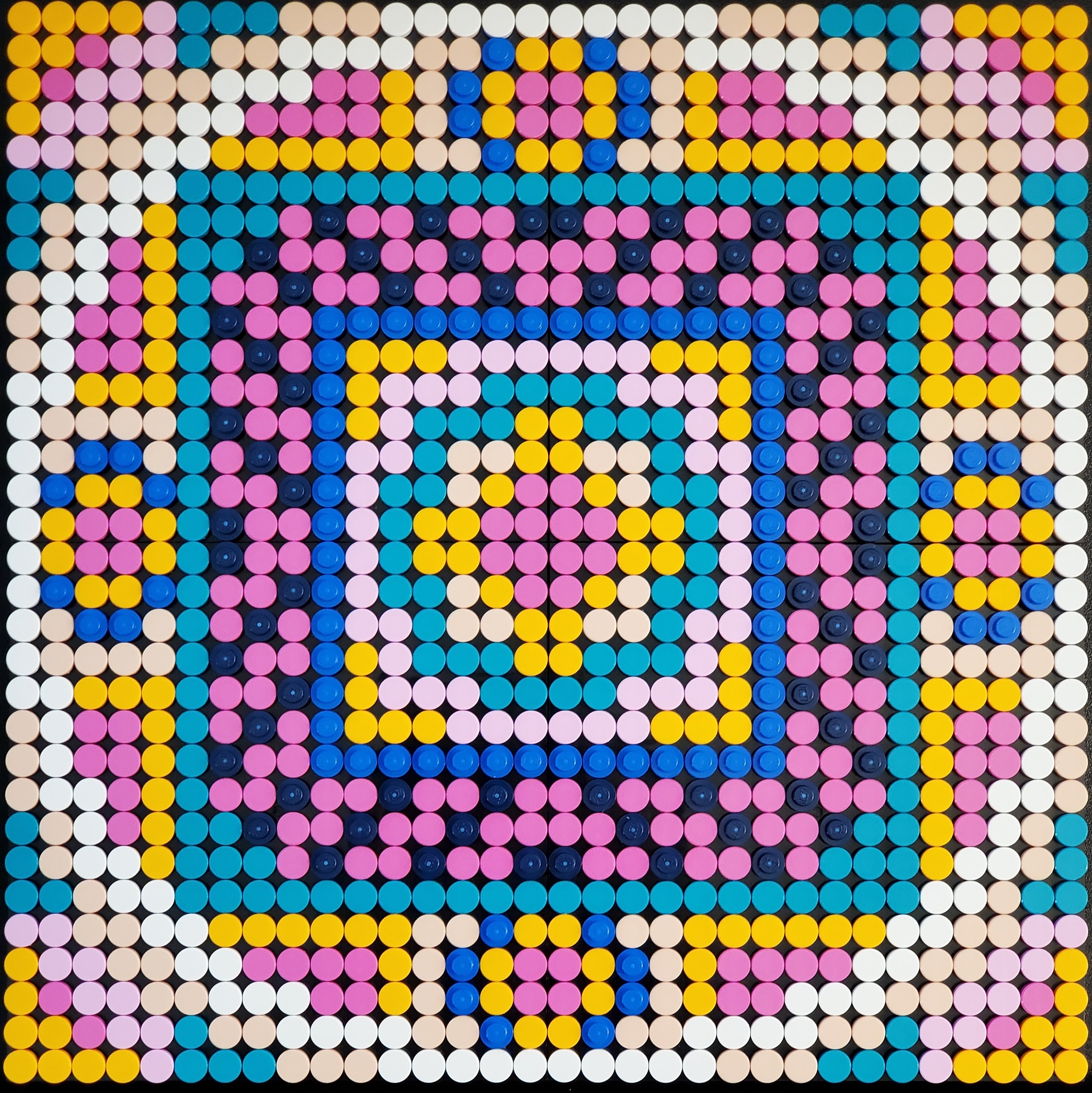 Mandala in shades of pink, blue, yellow and white.
